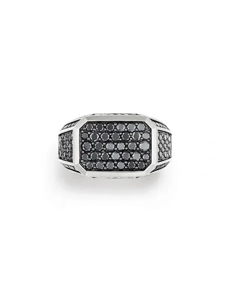 A silver ring with black diamonds on top of it.