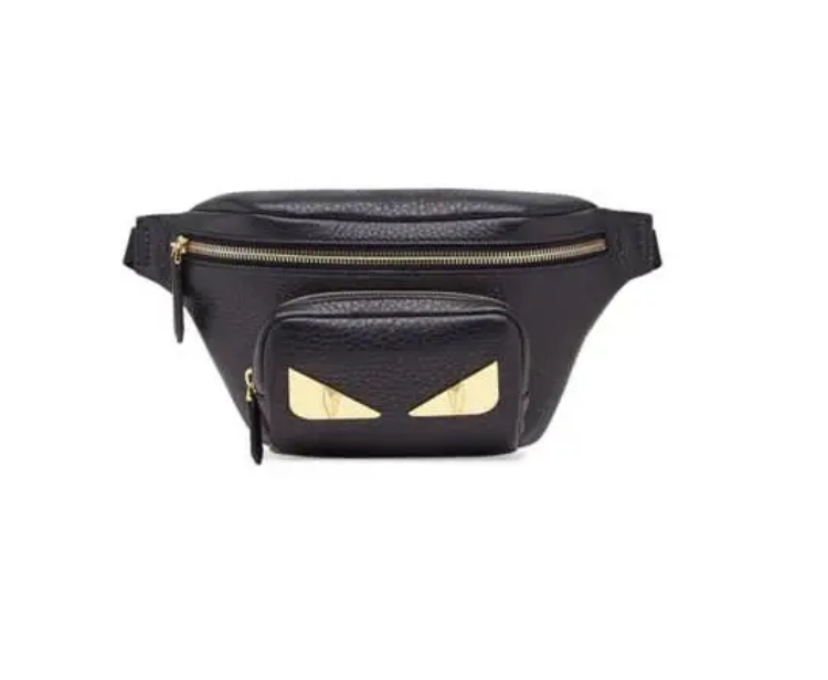 A black fanny pack with gold eyes on it.