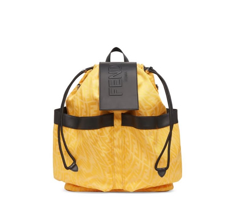 A yellow backpack with black straps and an fendi logo.