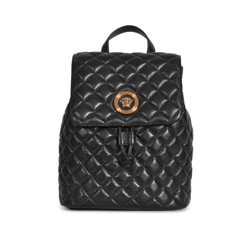 A black backpack with gold accents on it.