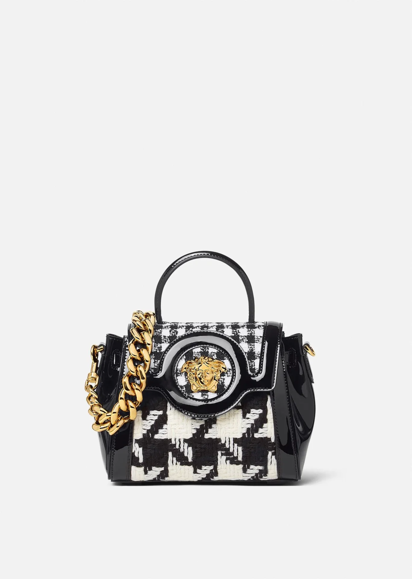 A black and white purse with gold chain.