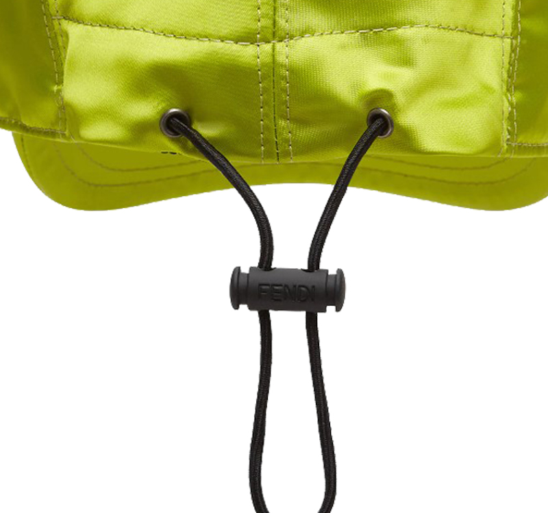 A baseball cap in acid green color with string