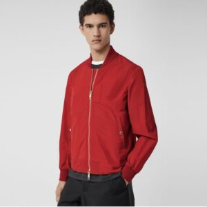 A male model wearing a red burberry bomber jacket