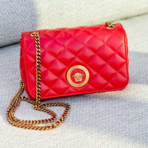 A bright red nappa quilted medusa hand bag