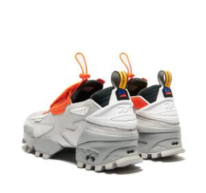 A side view of orange and white sneakers