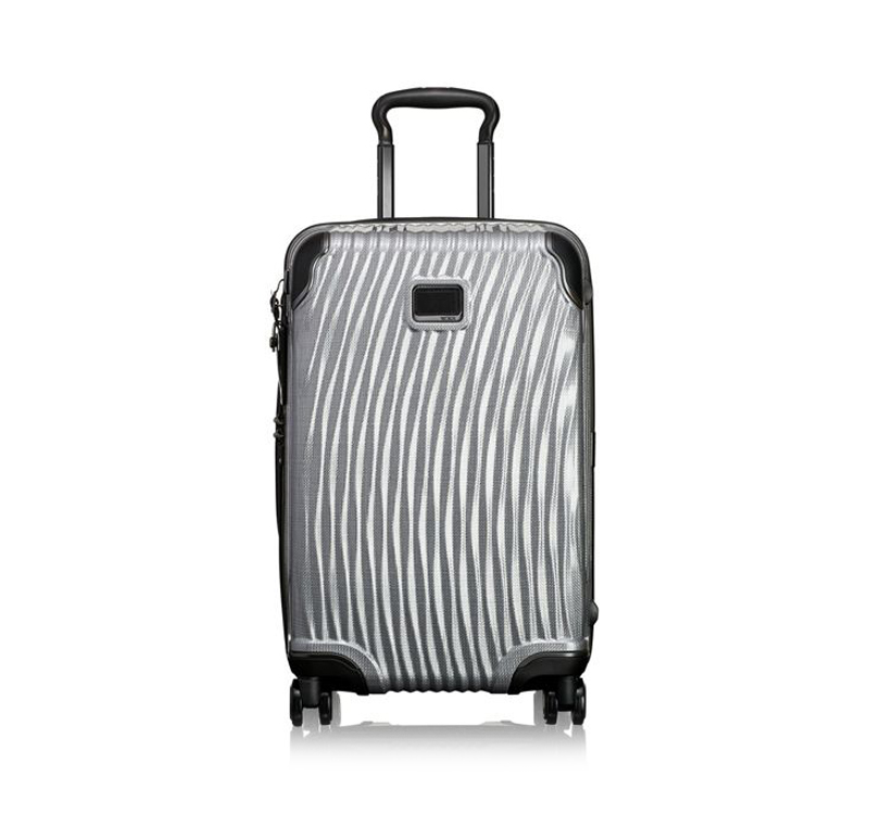 A silver suitcase is shown on the ground.