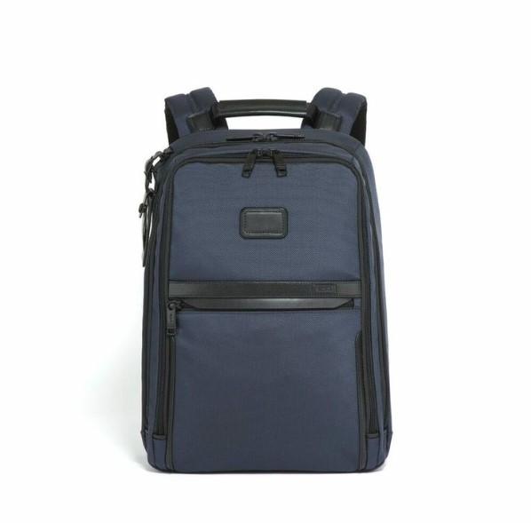 A dark navy tumi slip backpack with zipper