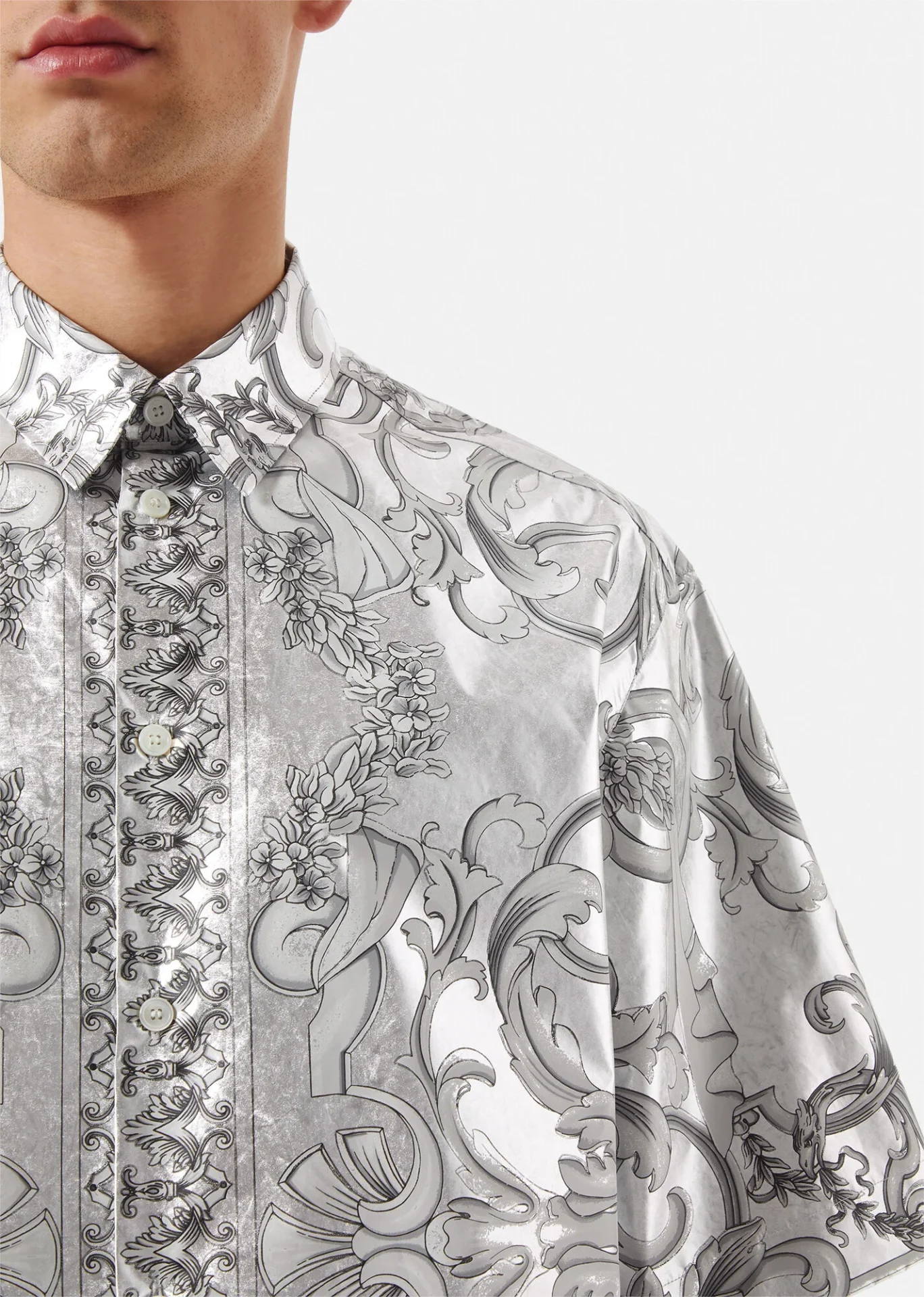 A close up of a versace silver silk baroque shirt