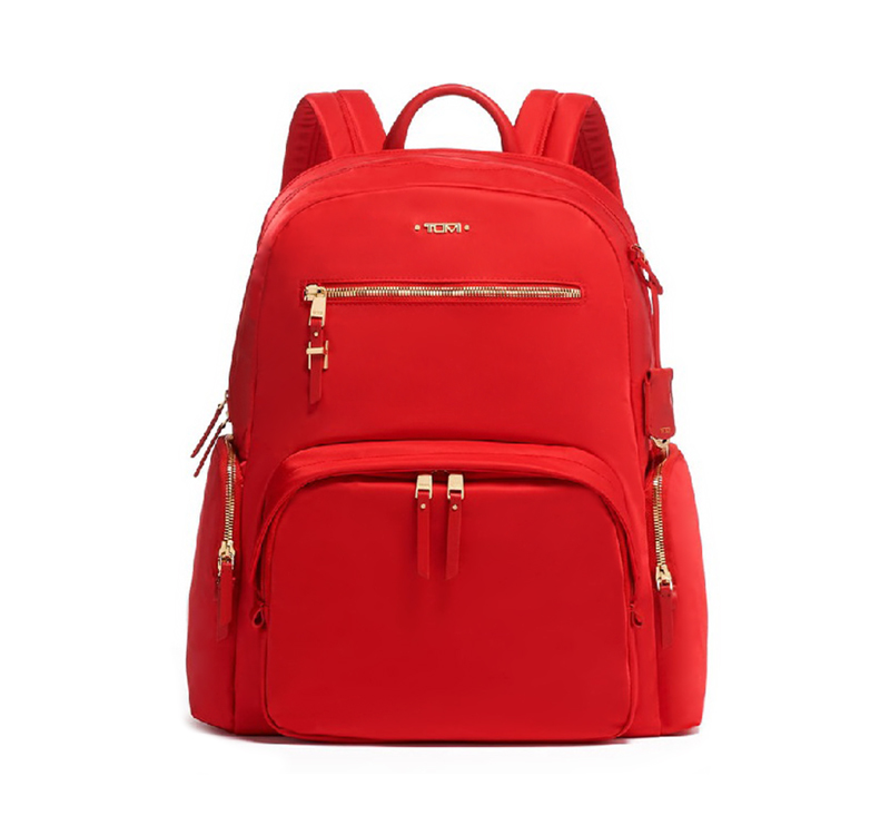 A red backpack with gold accents on it.