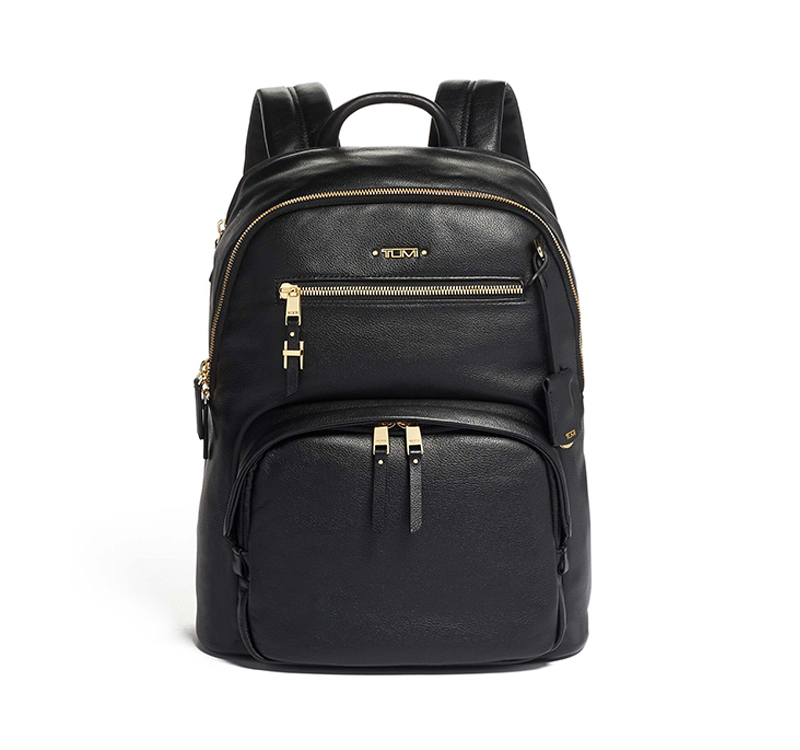 A black backpack with gold accents on it.